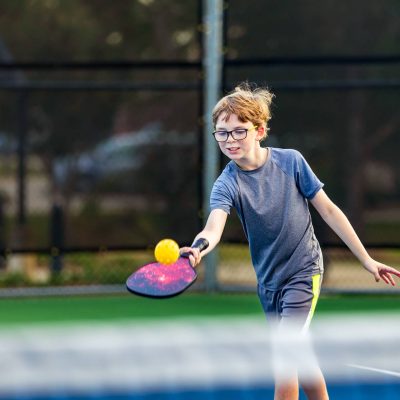 Teen is playing pickleball