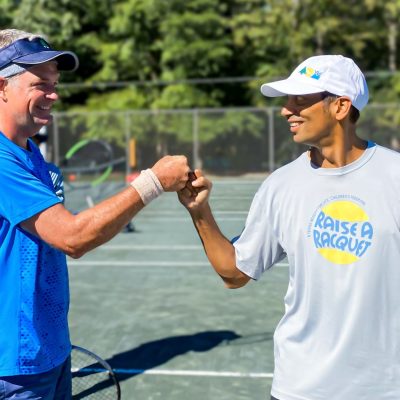 Friends celebrating victory at tennis tournament